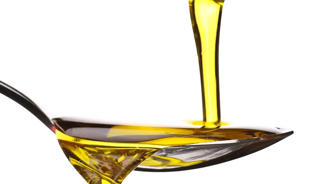 extra virgin olive oil being poured onto a spoon. Image shot 2008. Exact date unknown.