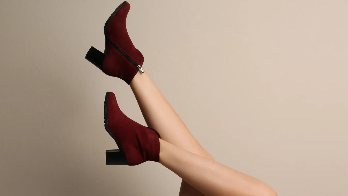 Woman,Wearing,Stylish,Boots,On,Beige,Background,,Closeup