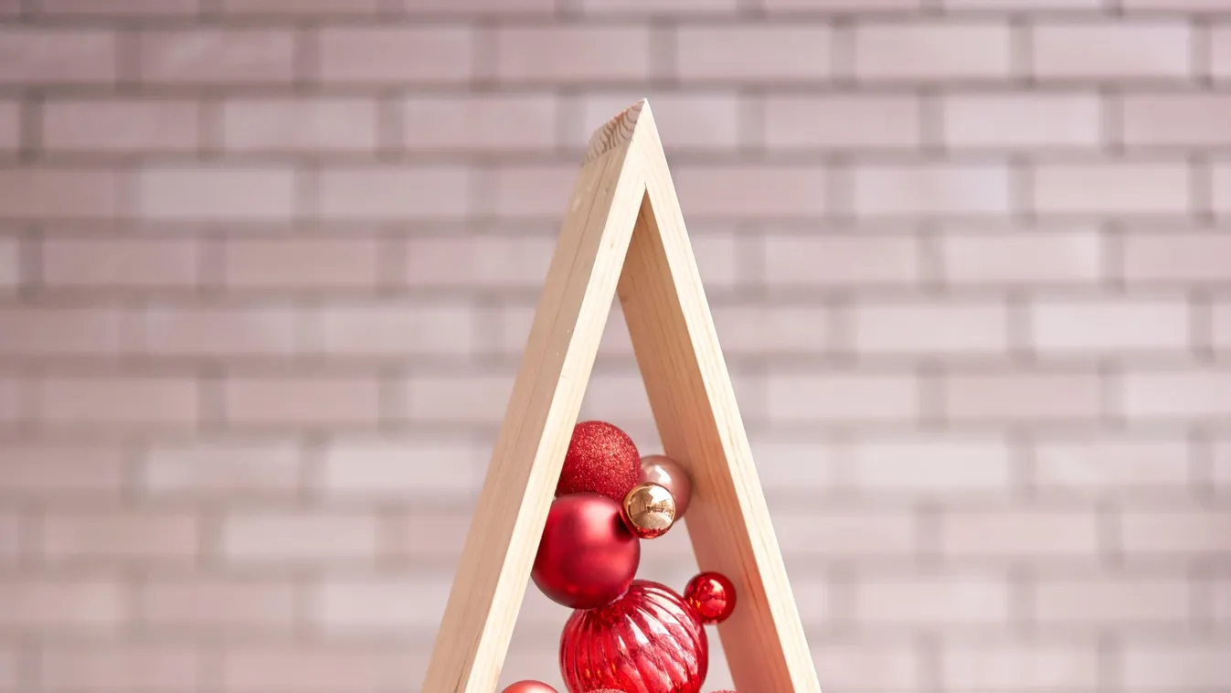 Alternative wooden christmas tree. A handmade Christmas tree and red christmas balls.