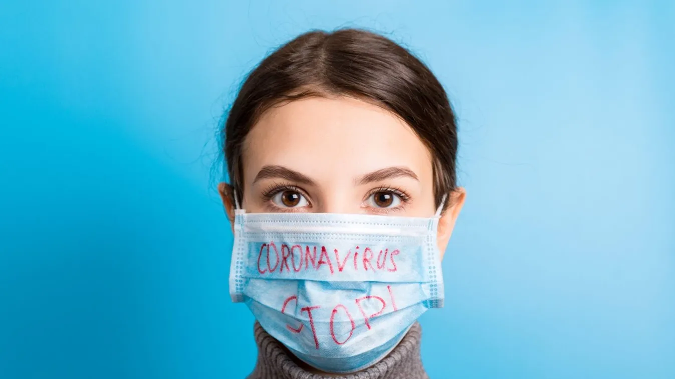 Portrait of a woman in medical mask with stop coronavirus text at blue background. Coronavirus concept. Respiratory protection.