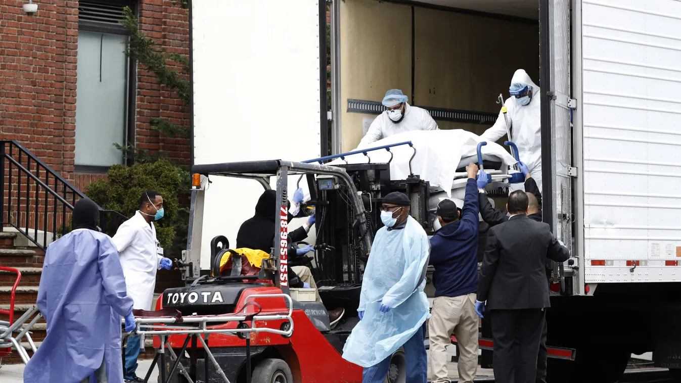 Workers load deceased person into truck trailer outside Brooklyn Hospital Center during the coronavirus disease (COVID-19) in New York