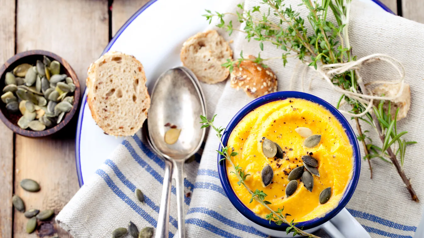 Roasted pumpkin and carrot soup with cream . 