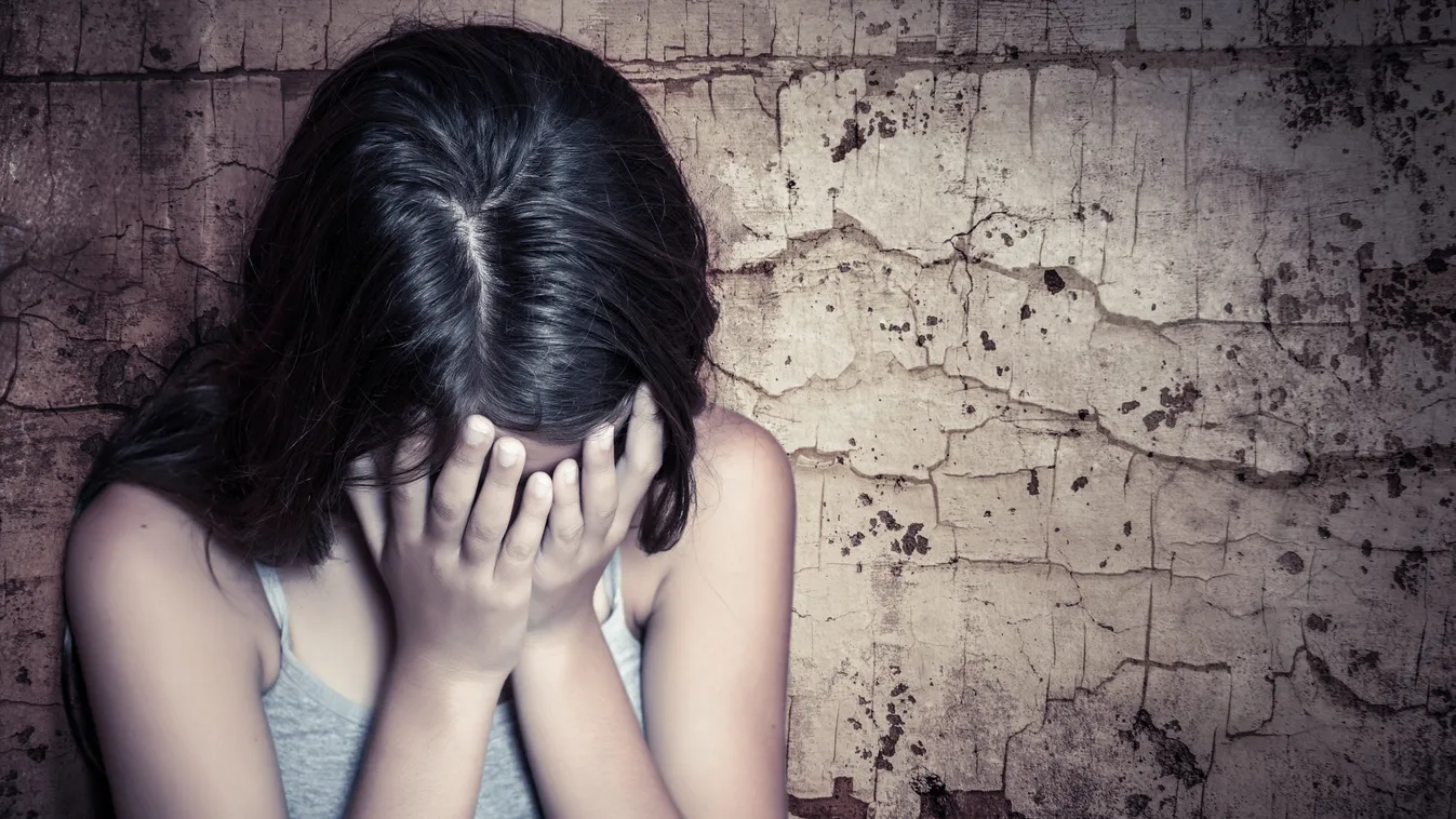 Teenage girl crying sitting on the floor