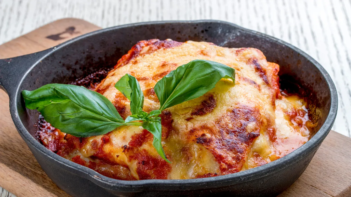 Lasagna,In,A,Cast,Iron,Pan,On,A,Wooden,Board.