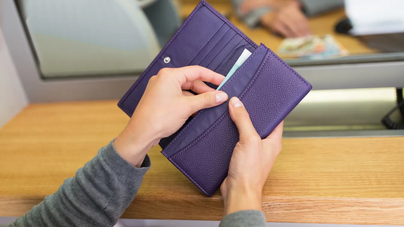 hands with money at bank or currency exchanger