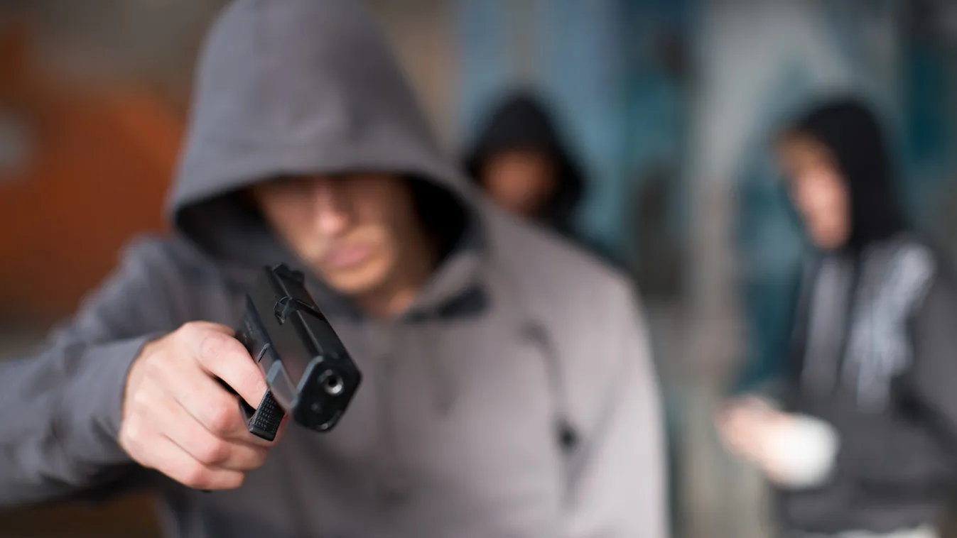 Man with gun pointed at viewer