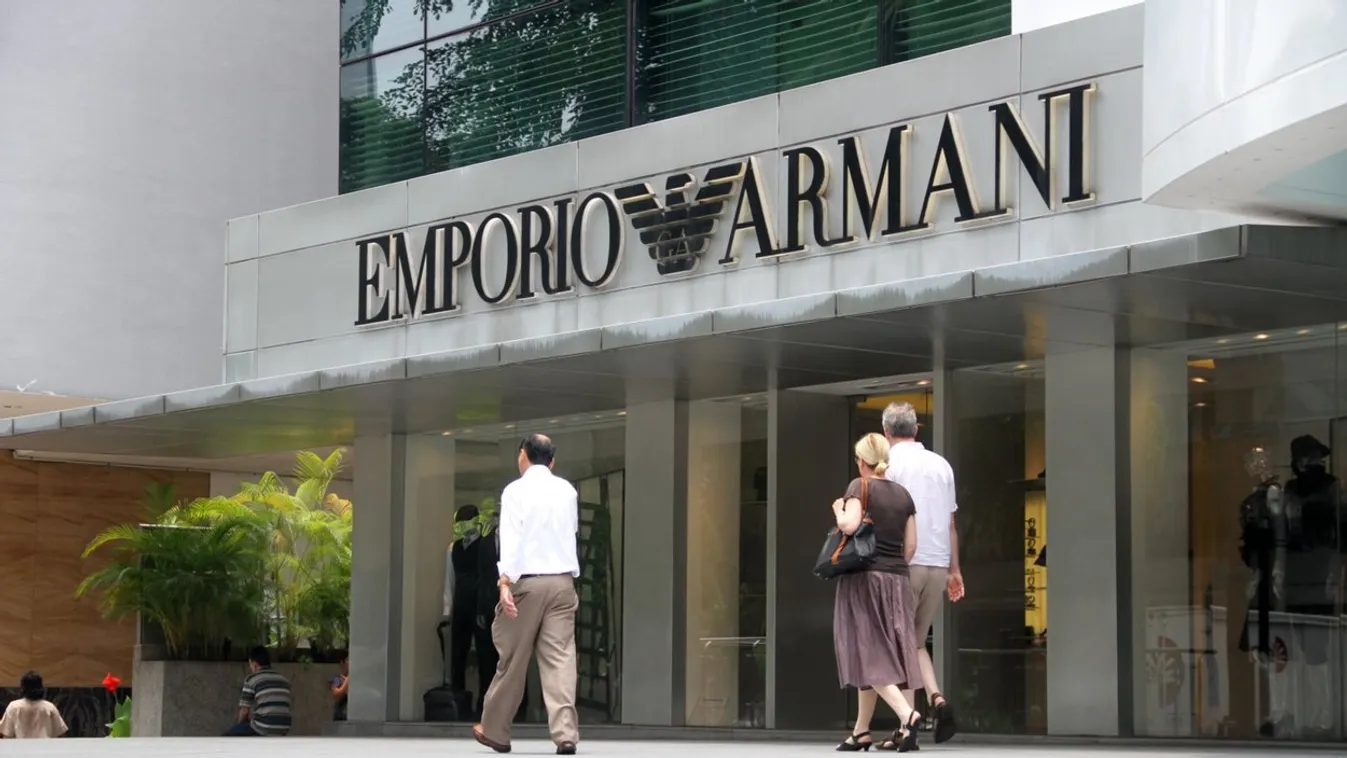 Shoppers walk past the Emporio Armani store on Orchard Road, Singapore