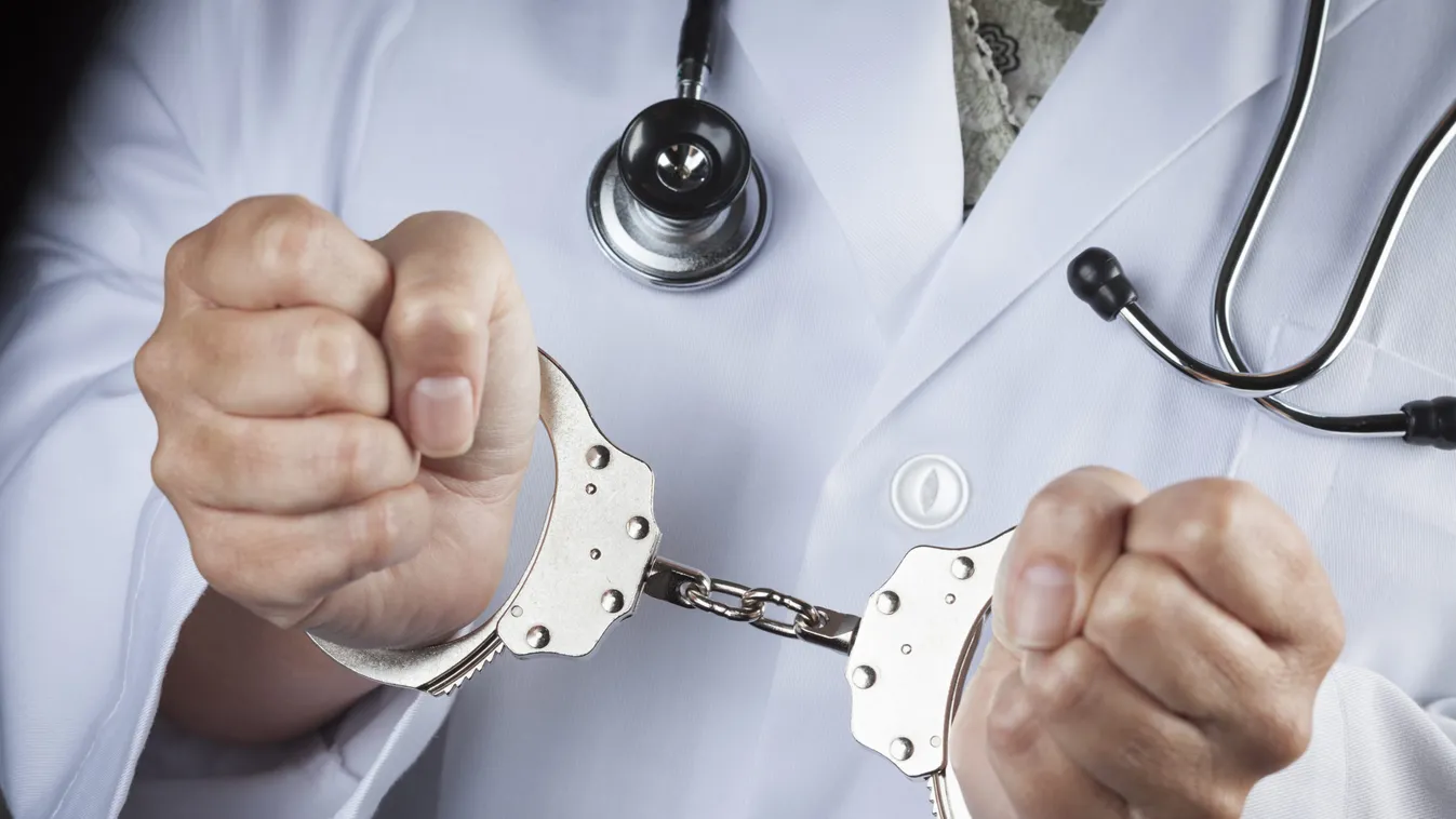 Female,Doctor,Or,Nurse,In,Handcuffs,Wearing,Lab,Coat,And
