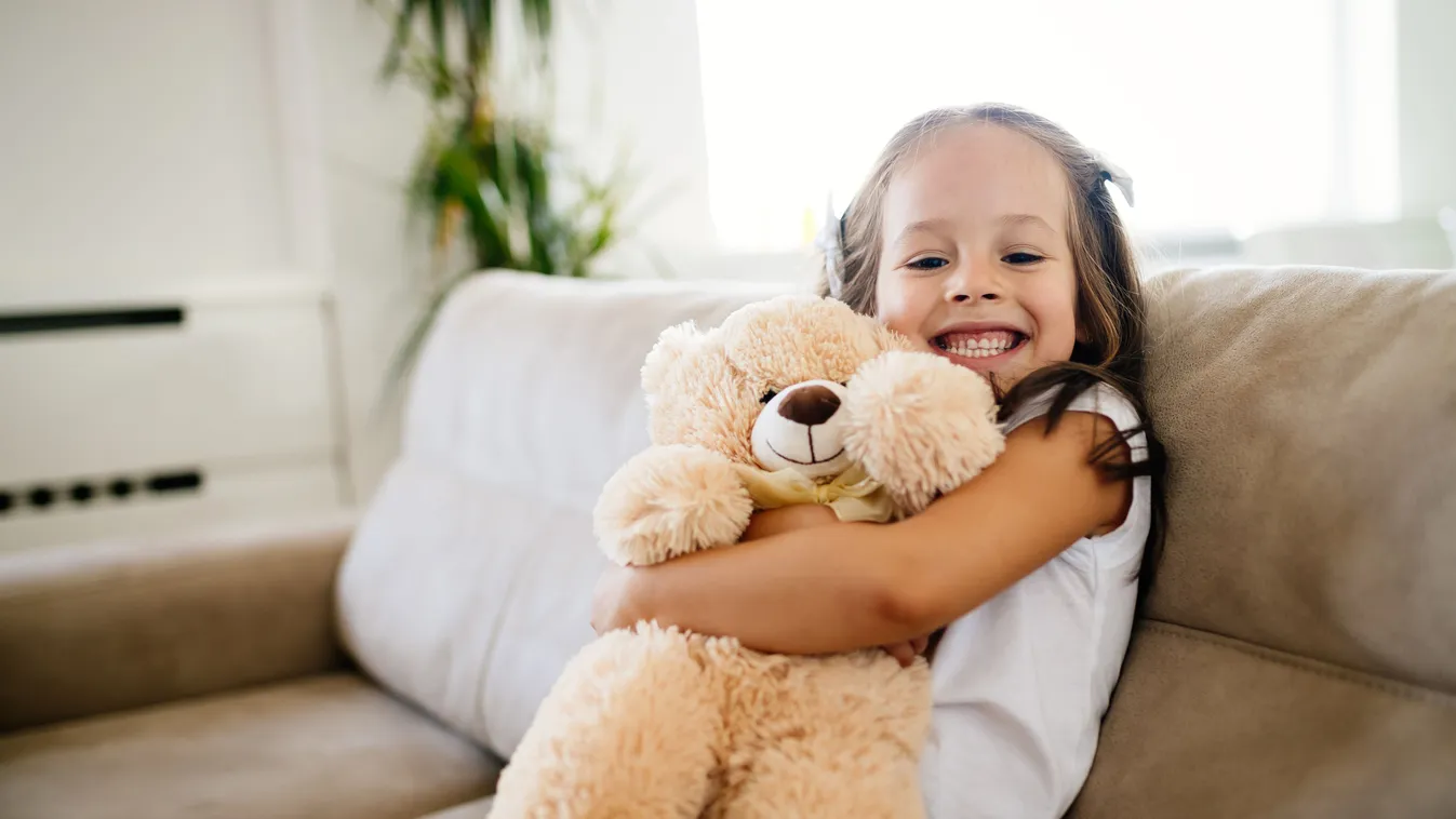 Cute little girl playing with teddy bear