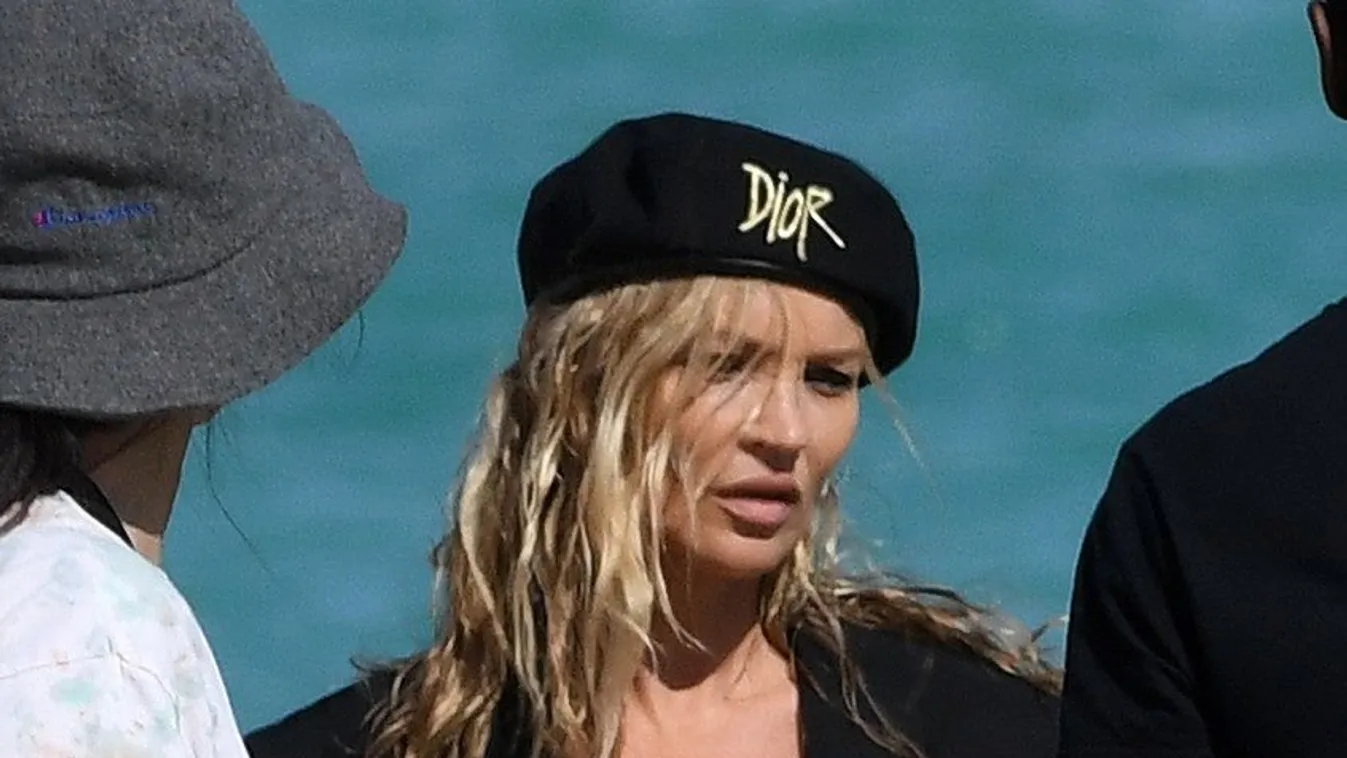 PREMIUM EXCLUSIVE: *NO WEB UNTIL 1700 EST 8TH DEC* Supermodel Kate Moss goes completely topless under a trench coat during a photoshoot on the beach in Miami