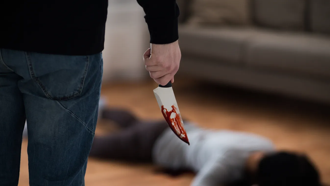 criminal with knife and dead body at crime scene