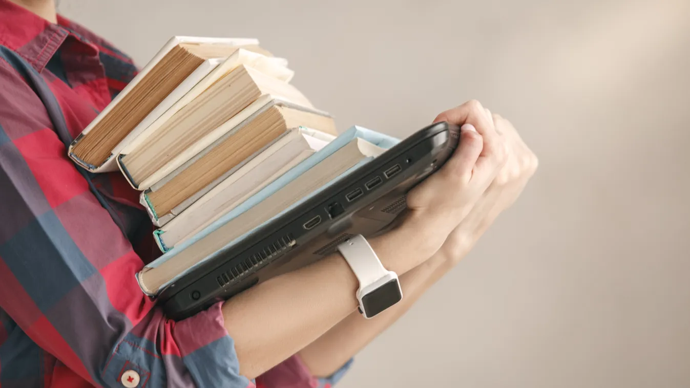 Young woman with books studio portrait education