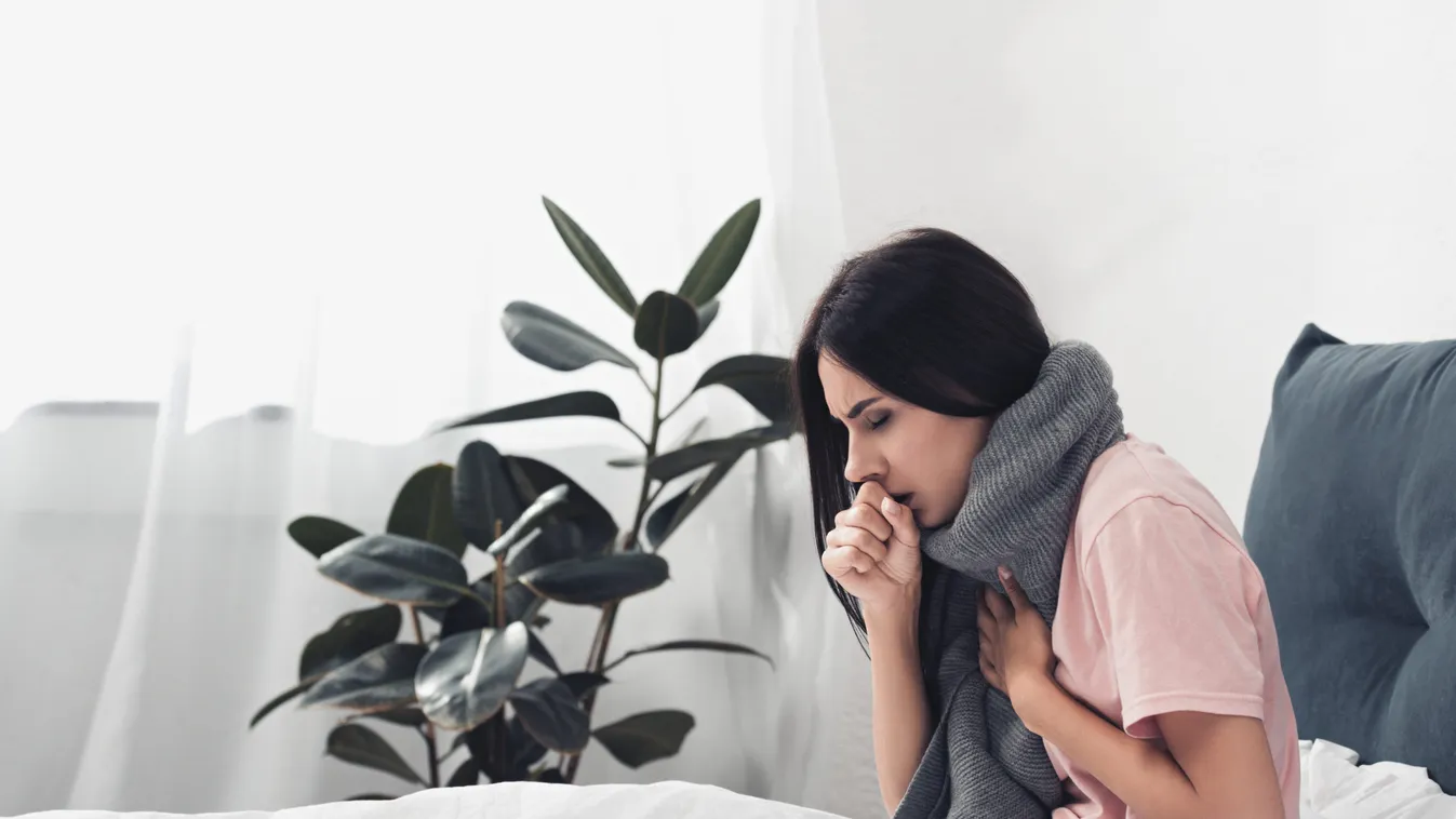 Sick,Young,Woman,Sitting,In,Bed,And,Having,Cough,While