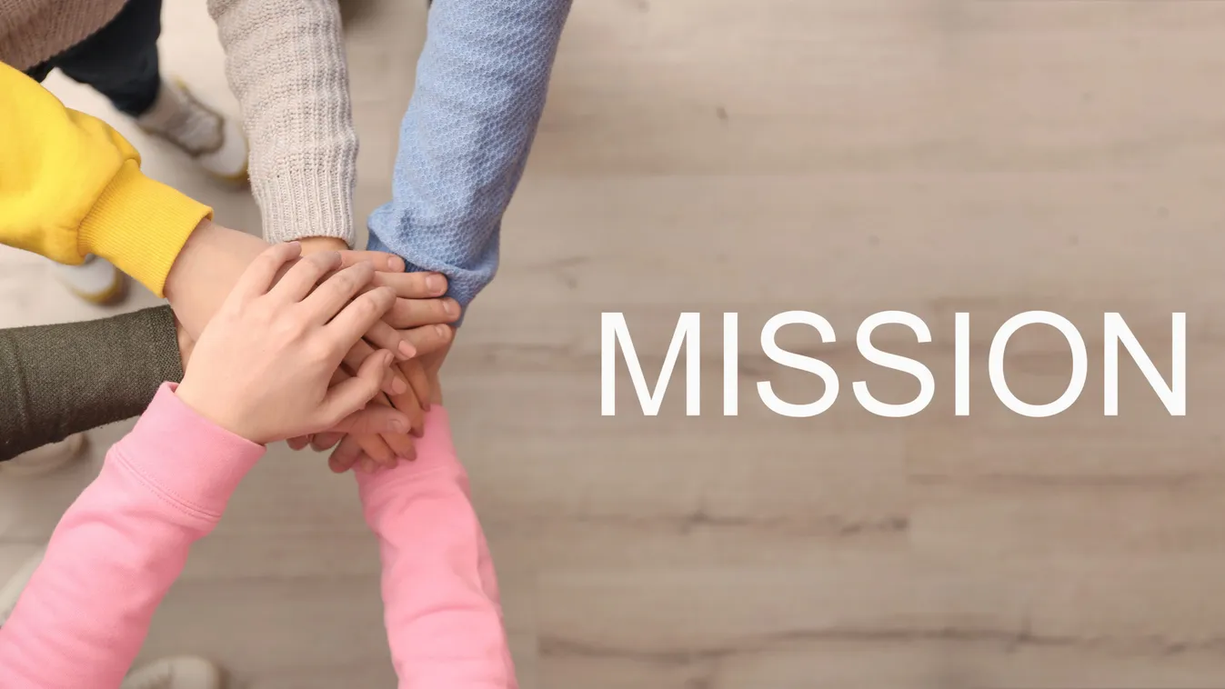 People,Holding,Hands,Together,Over,Wooden,Background,And,Text,Mission,