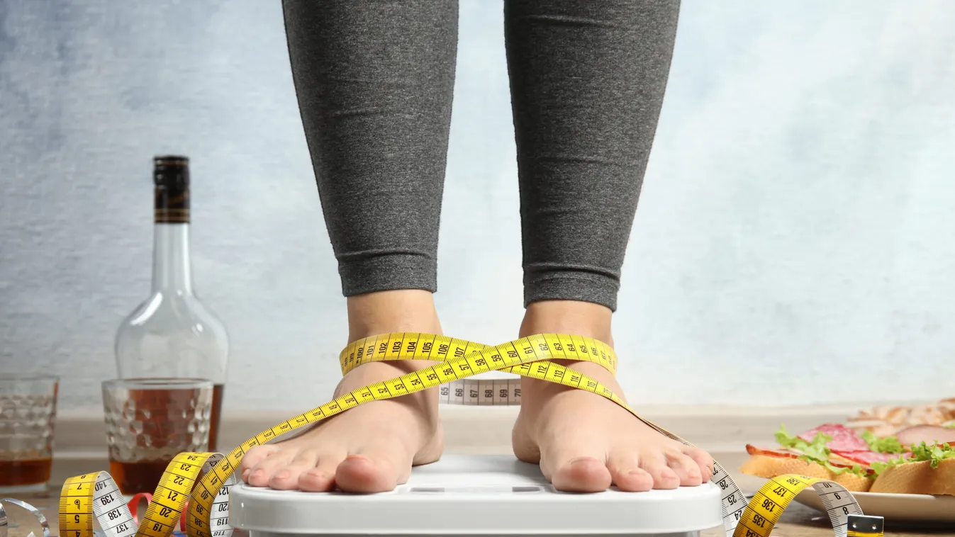 Woman,With,Measuring,Tape,Using,Scale,Surrounded,By,Food,And