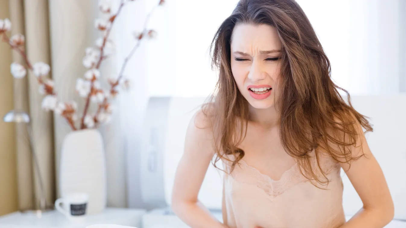 Beautiful,Young,Woman,In,Lingerie,Sitting,On,Bed,And,Suffering