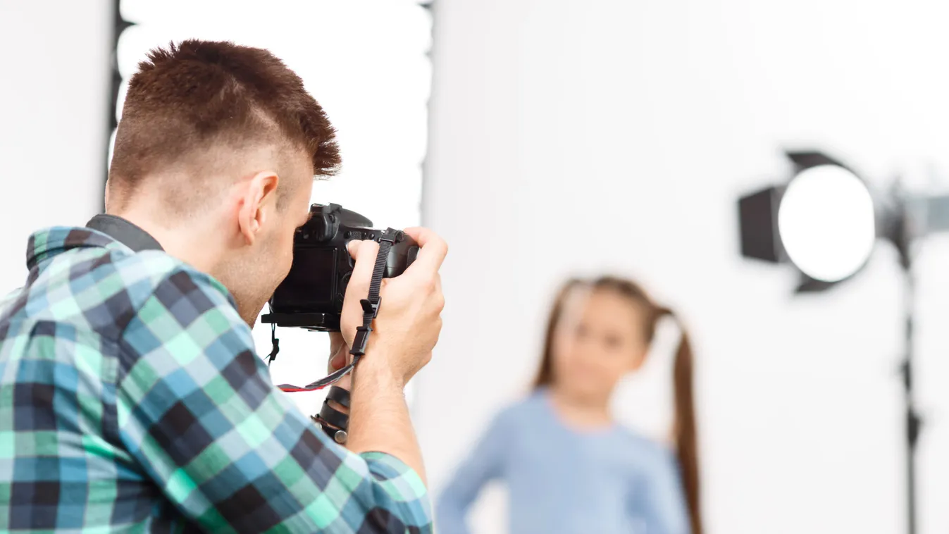 Young photographer is busy during photoshoot. 