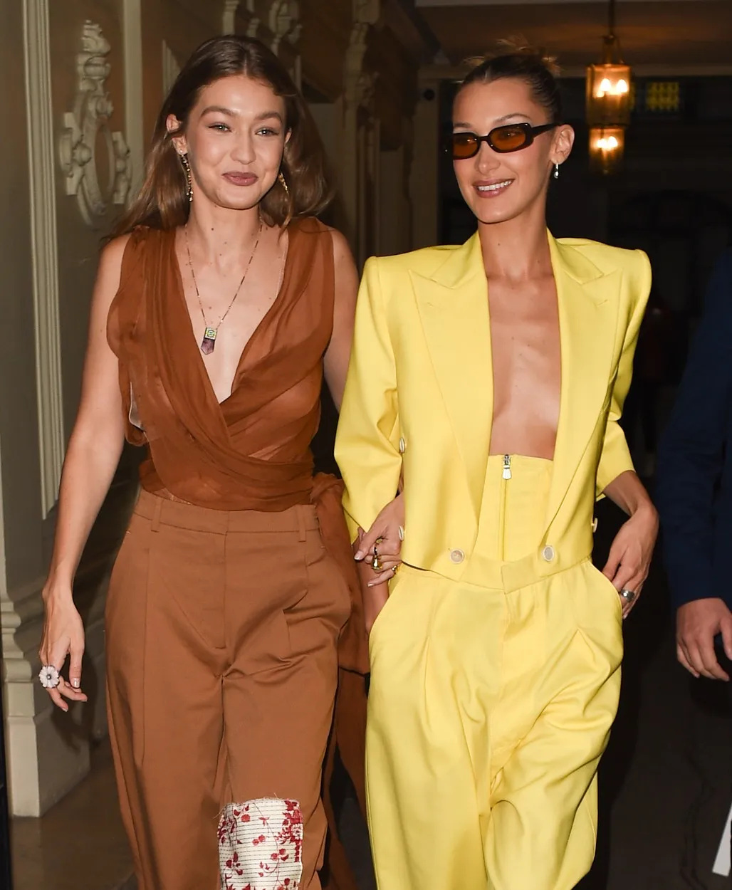 Gigi Hadid & Bella Hadid hold arms and laugh and smile as they are seen at 'The Americans In Paris' event at Paris fashion week, Kendall Jenner
