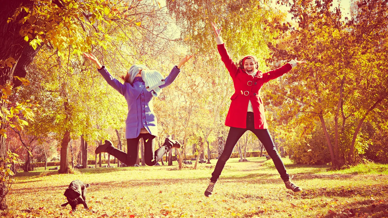 Happy,Women,Jumping,Outside,At,Autumn,Fall