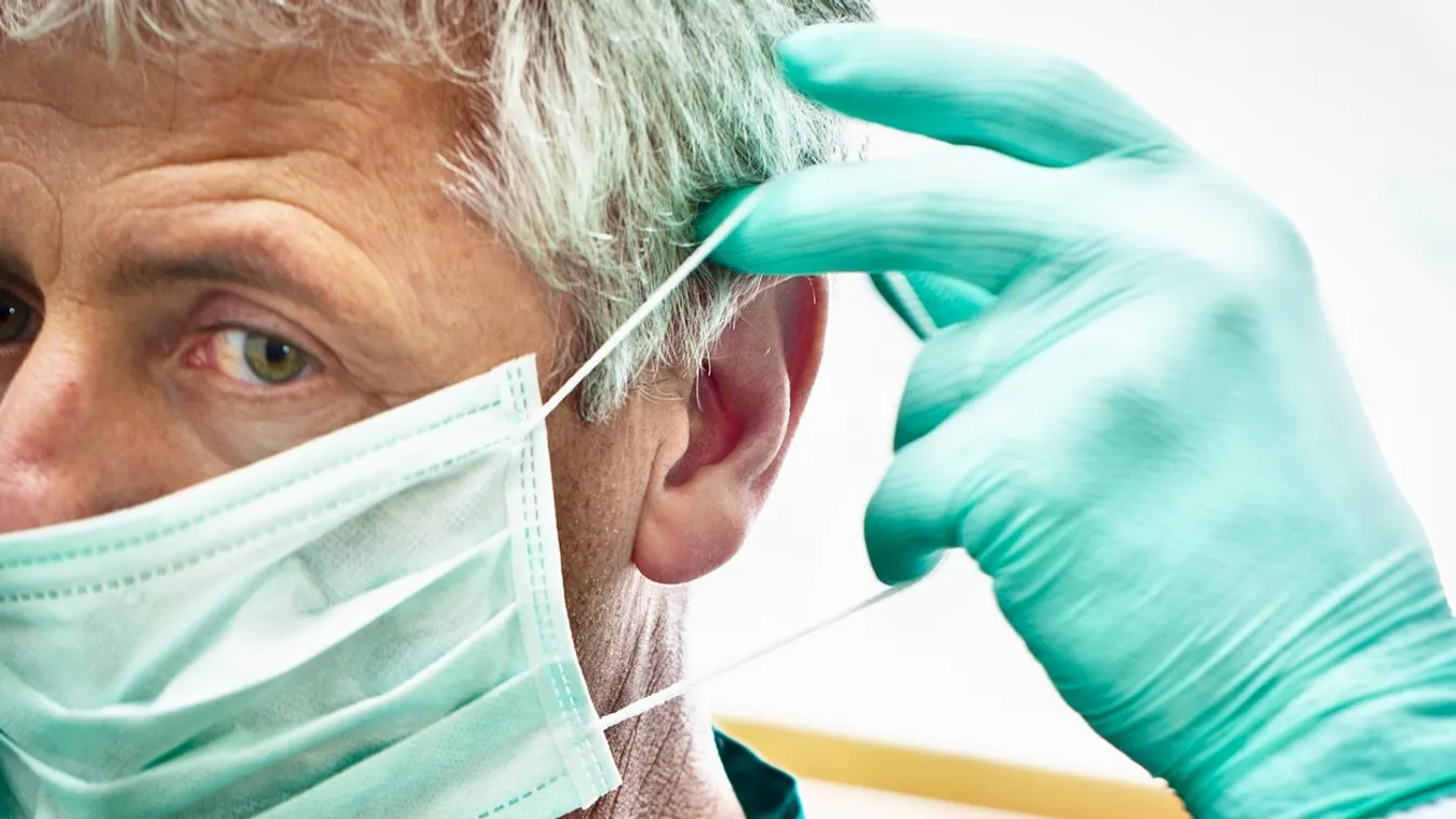 Dentist putting on face mask