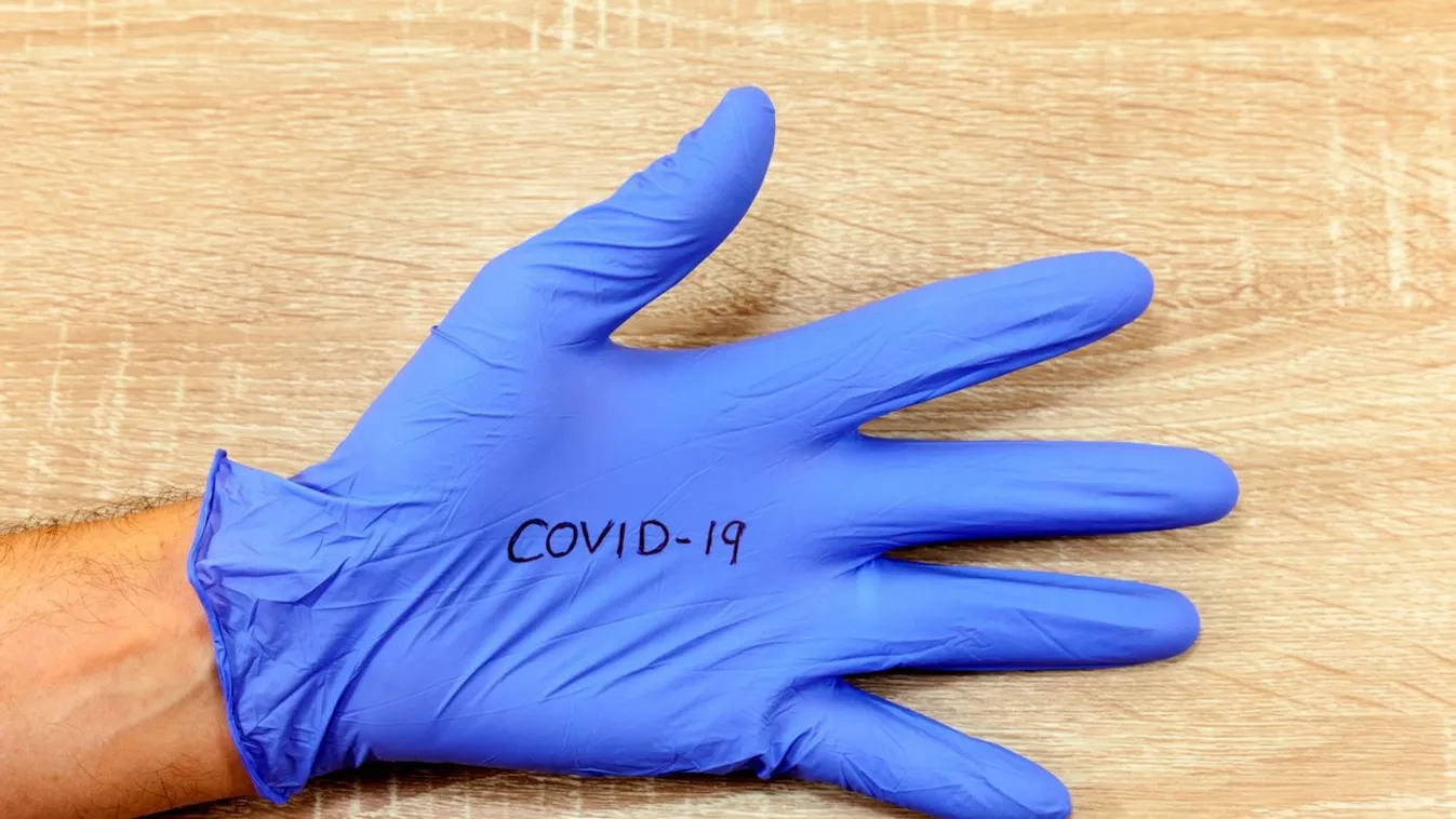 The word 'Covid-19' written on a hospital glove