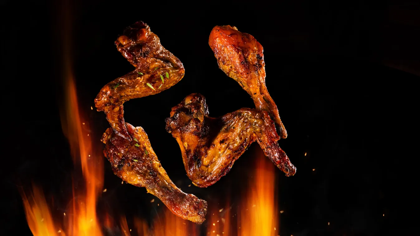 Flying,Pieces,Of,Chicken,Meat,On,Grill,With,Fire,Flames.