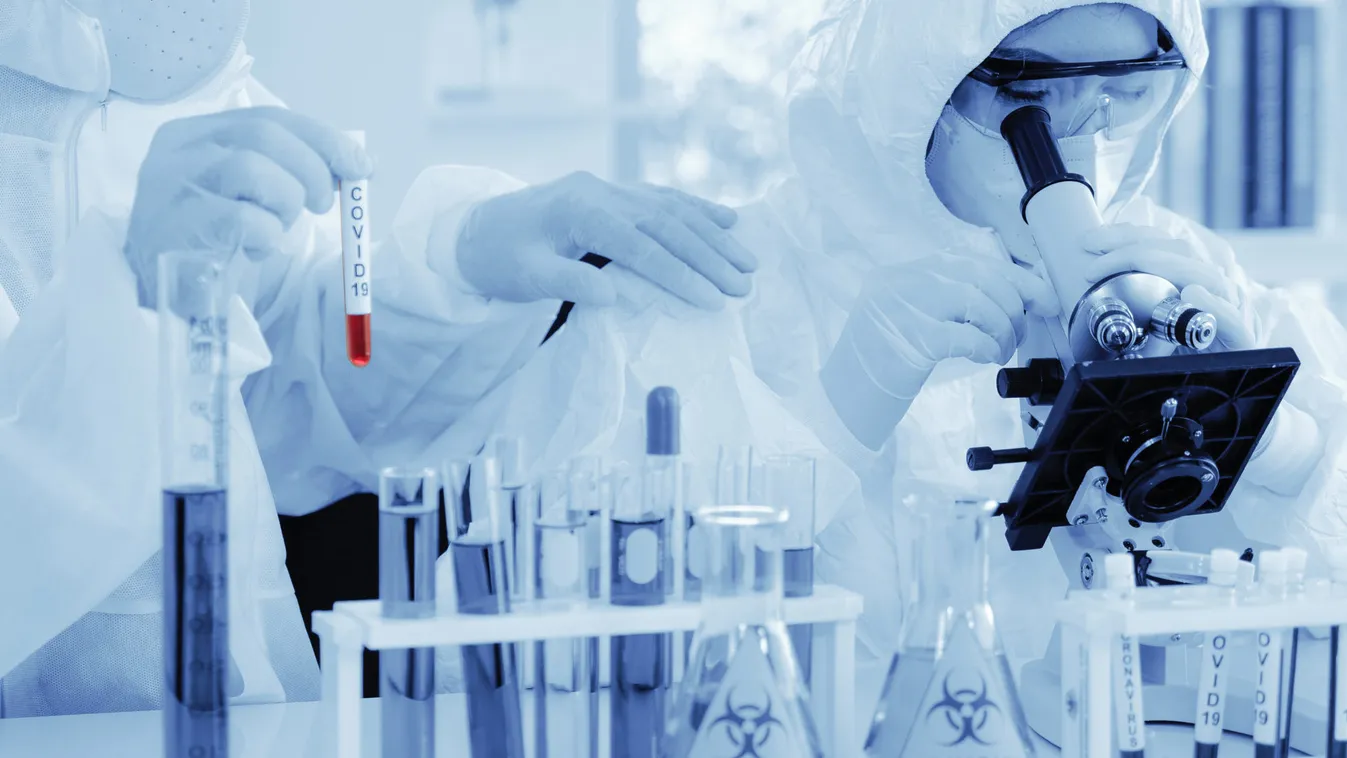 Scientist,In,Biohazard,Protection,Clothing,Analyzing,Covid,19,Sample,With