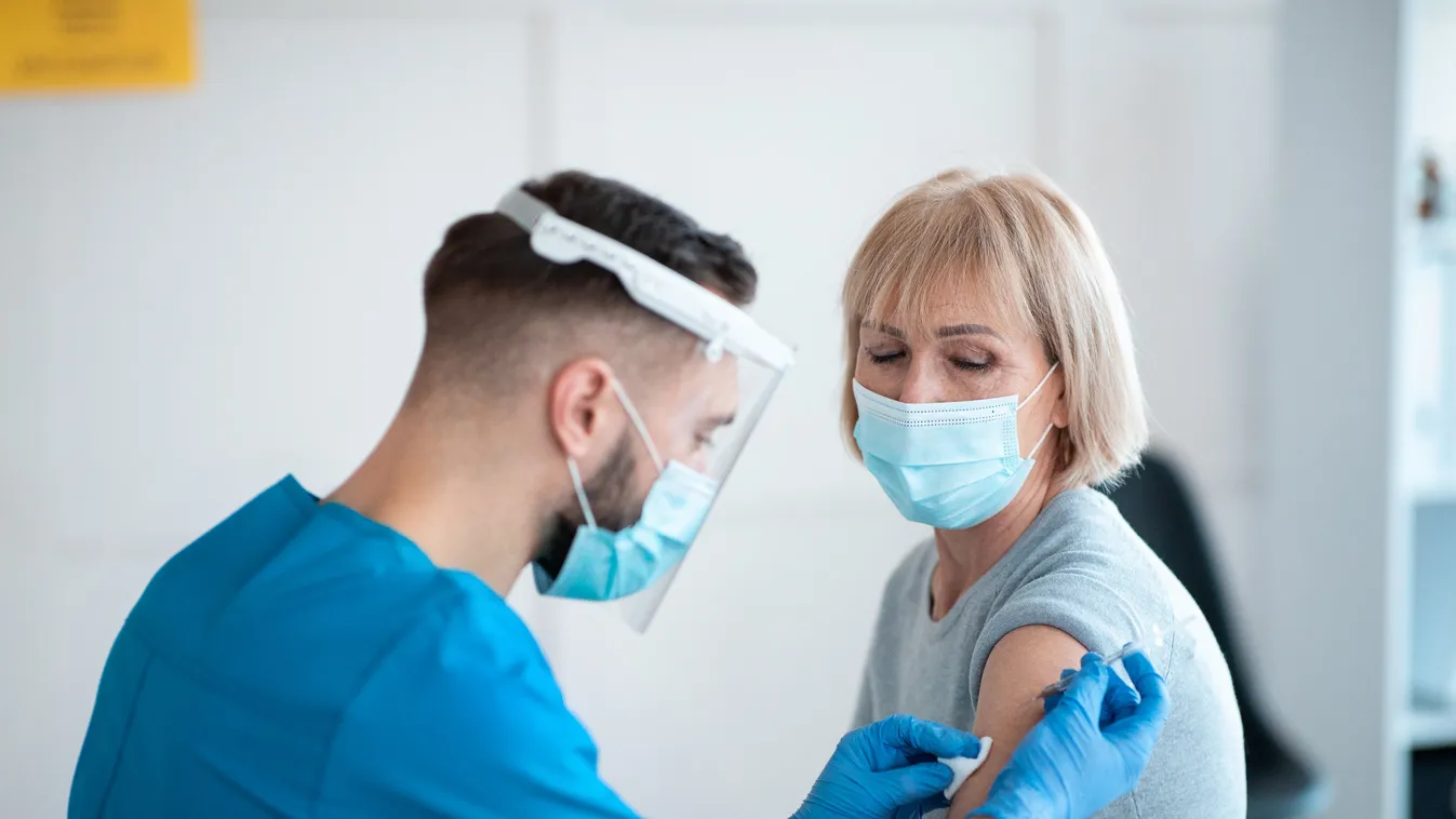 Coronavirus prevention and treatment concept. Senior female patient getting vaccinated against covid-19 at clinic