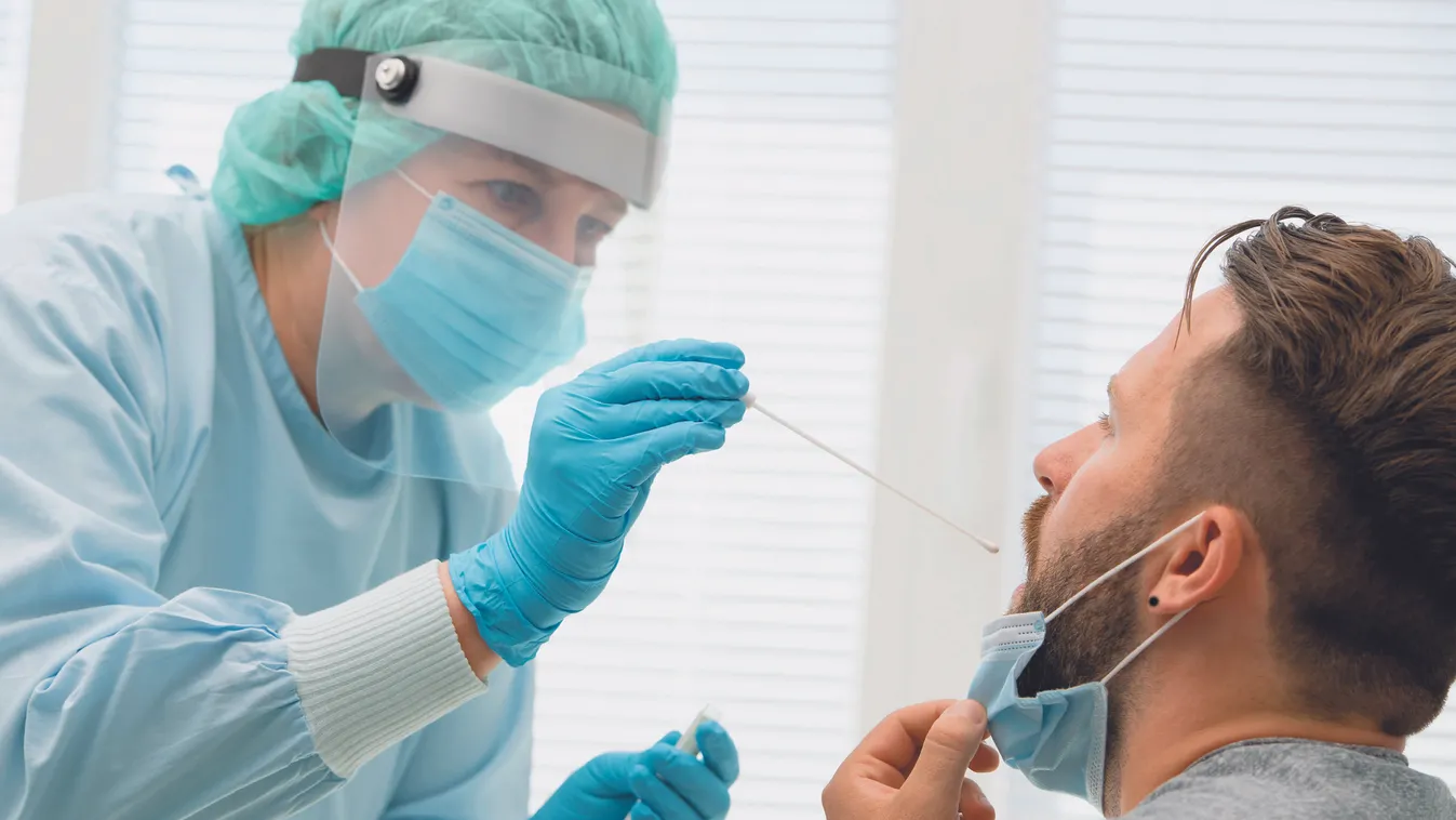 Doctor,In,A,Protective,Suit,Taking,A,Throat,And,Nasal