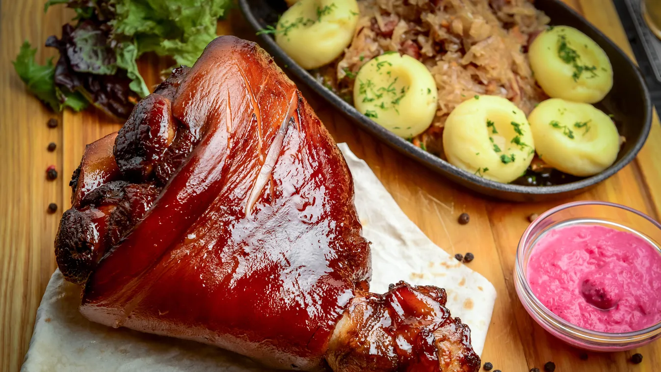 Baked,Pork,Shank,With,Sauerkraut,On,A,Wooden,Table