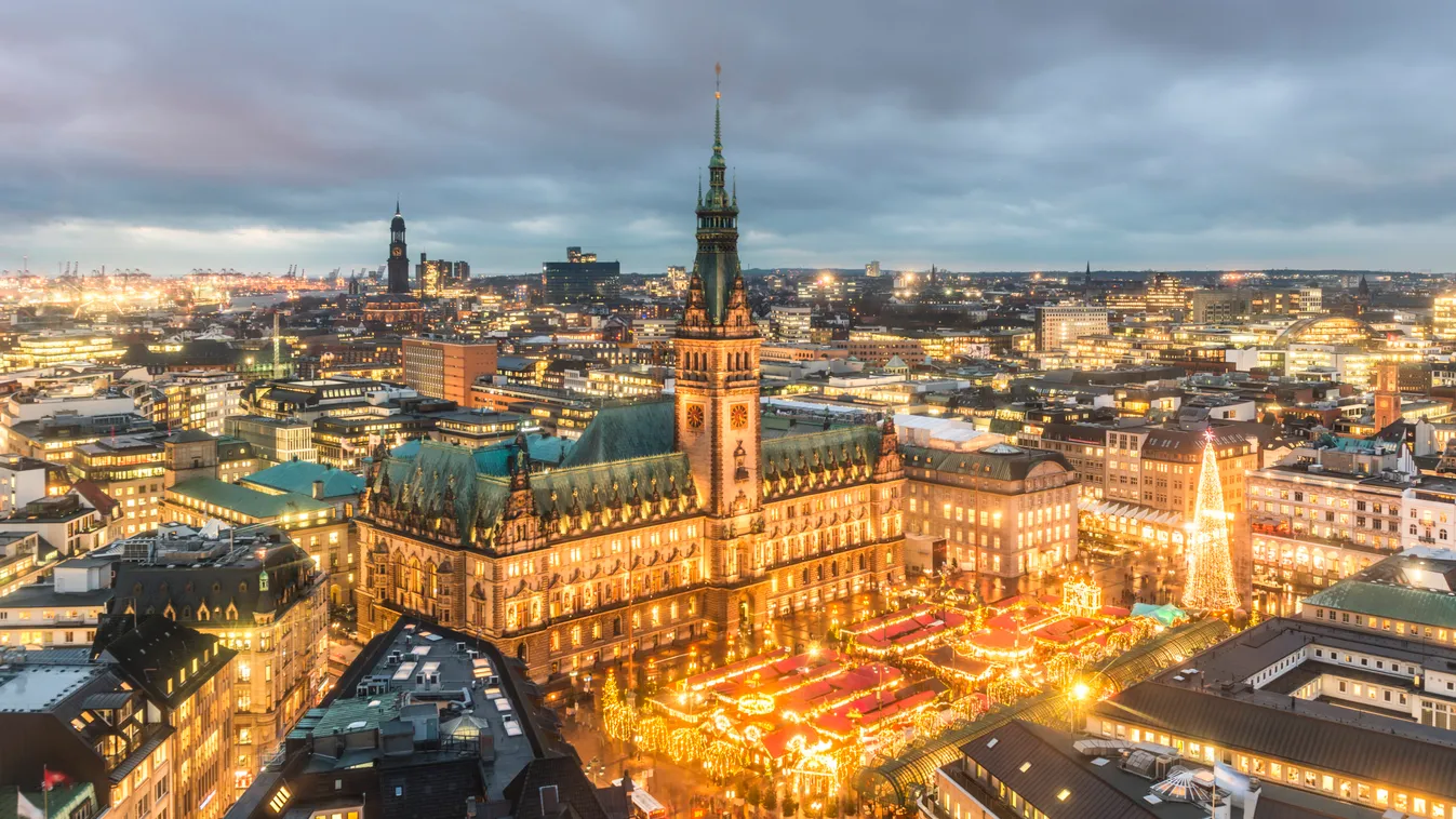 Germany, Hamburg, Christmas market at town hall in the evening