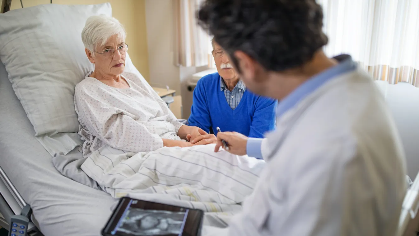 Doctor explaining the knee replacement treatment to senior patient