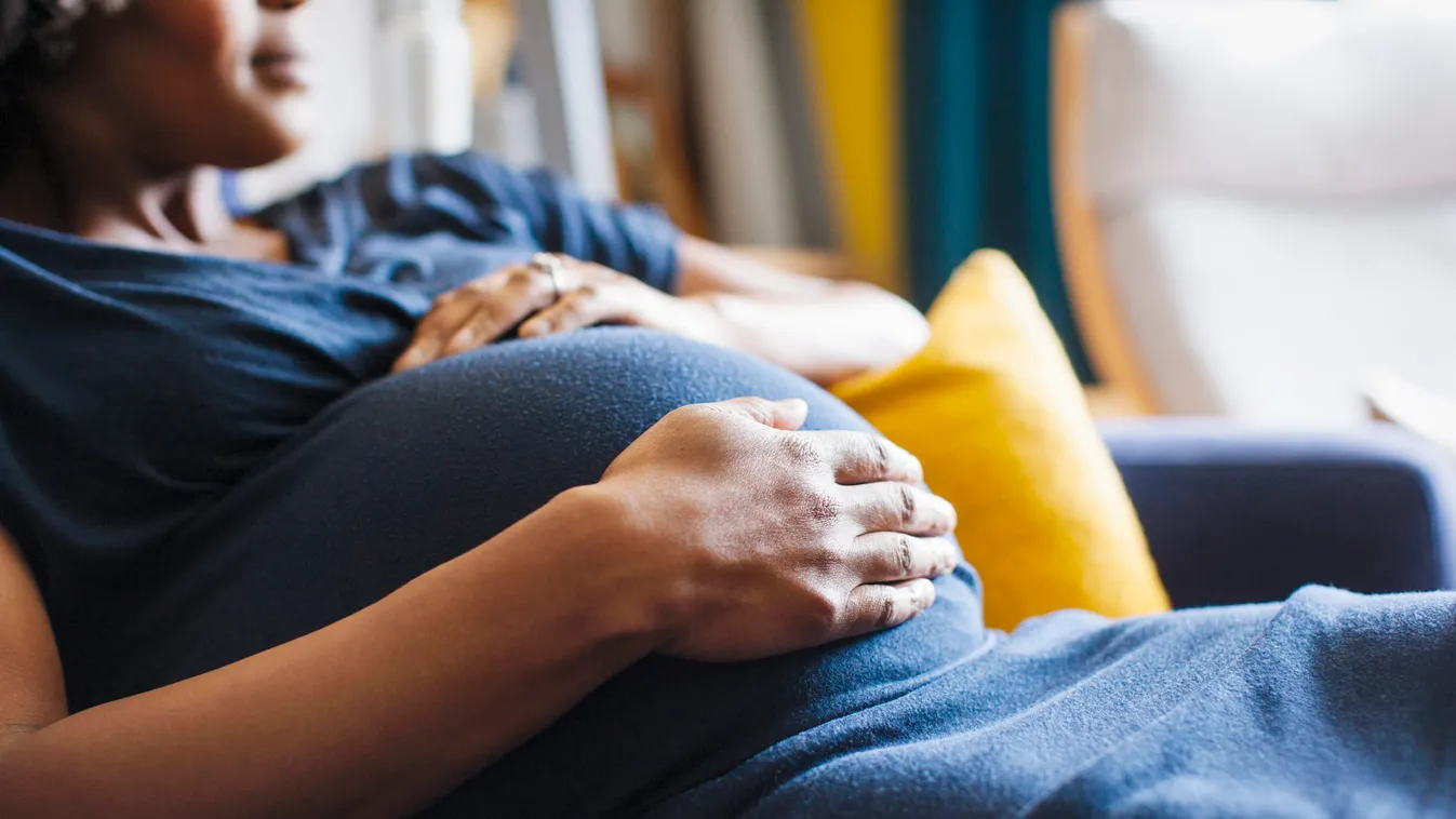 Close up pregnant woman rubbing stomach