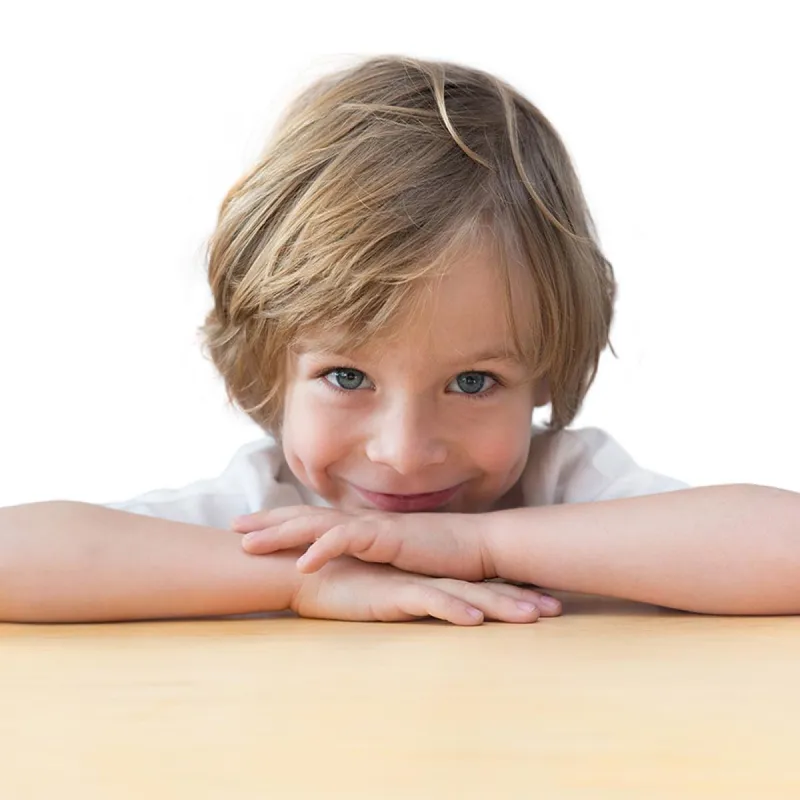 Closeup,Of,Adorable,Little,Boy,On,The,Table,Edge,,Smiling,