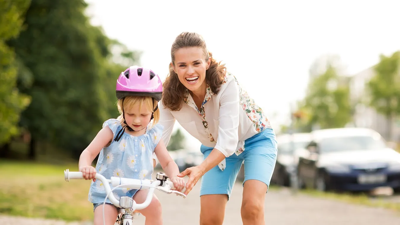A,Laughing,,Smiling,Mother,Pushes,Her,Daughter,Forward,On,A