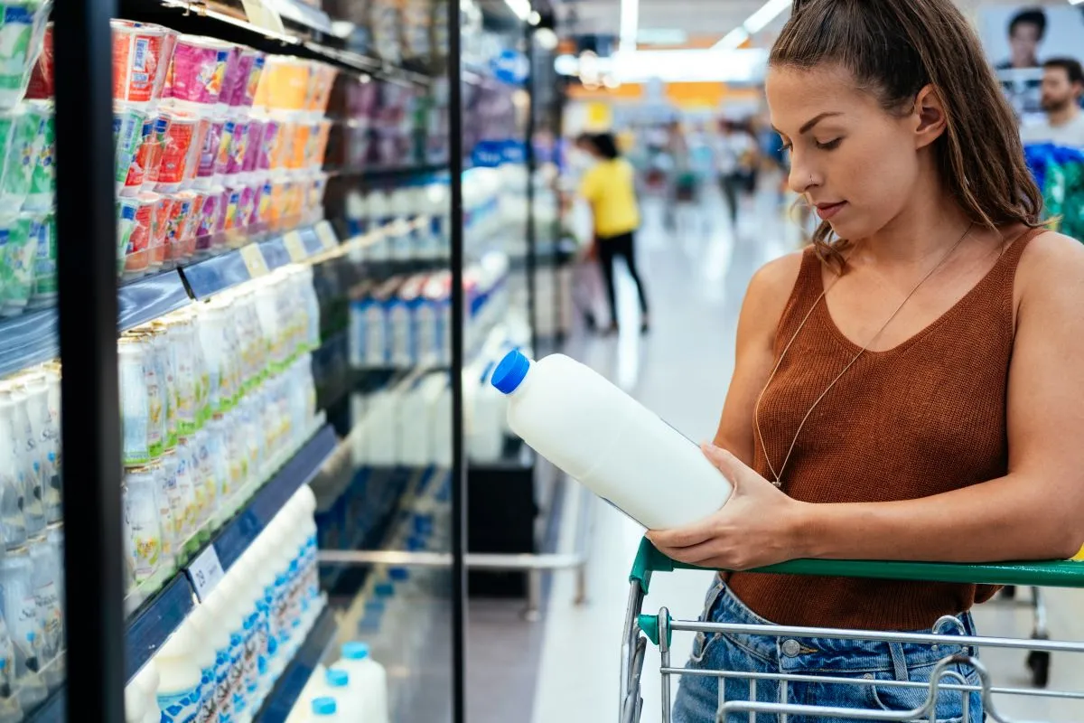 Female,Buying,Milk,In,Supermarket,Stock,Photo.,Young,Woman,Checking