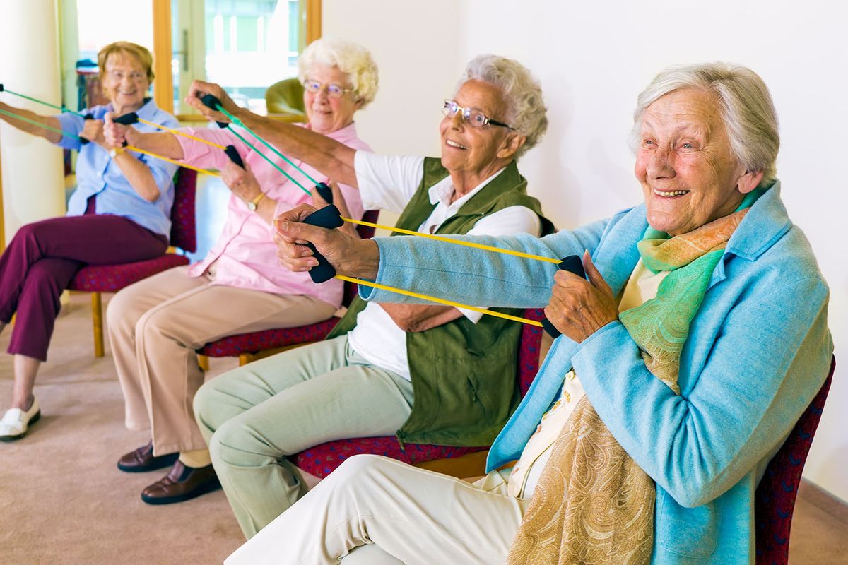 Group,Of,Four,Smiling,Senior,Women,Toning,Their,Arms,With