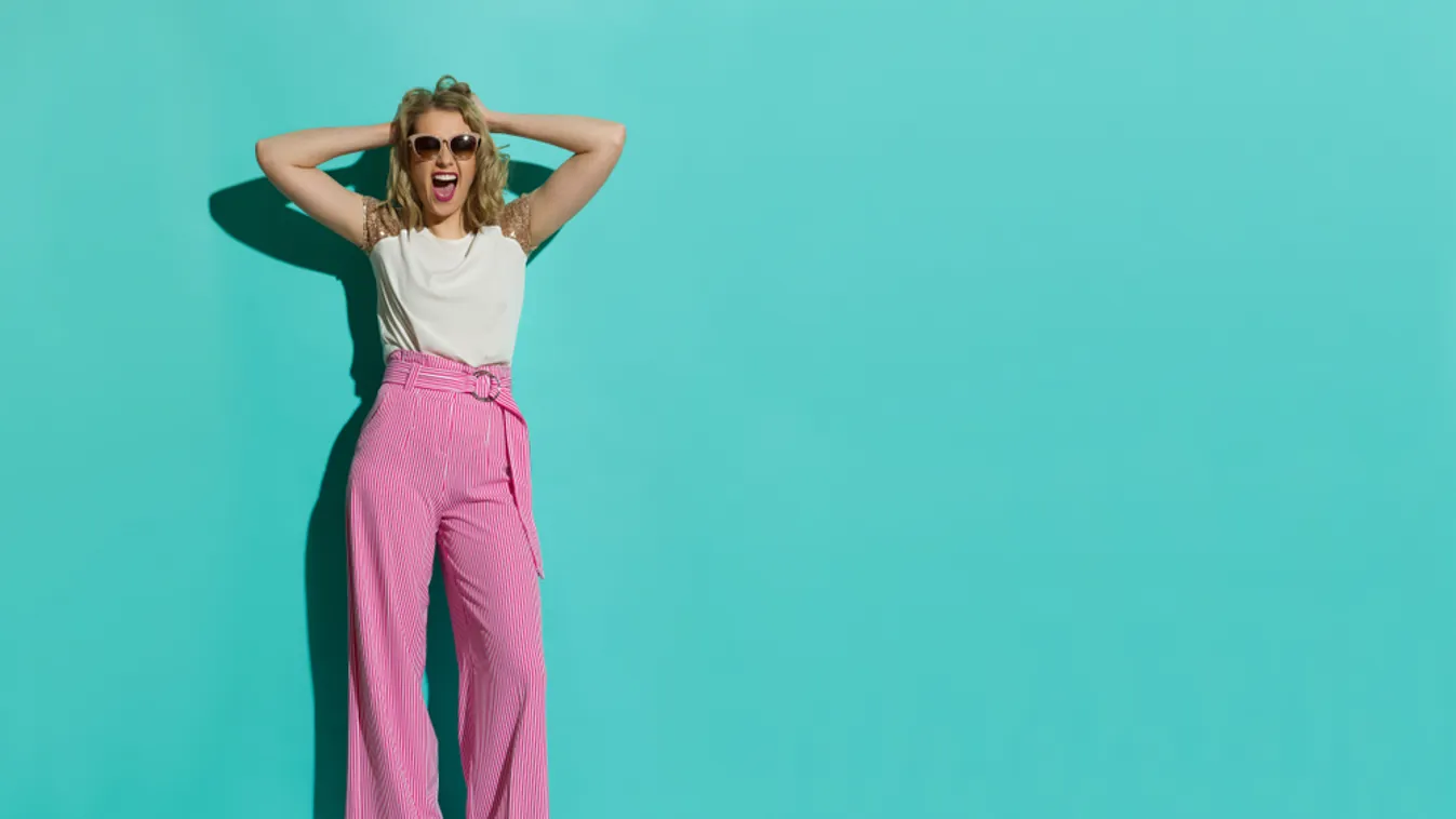 Young,Woman,In,Red,Striped,Wide,Leg,Trousers,And,Sneakers