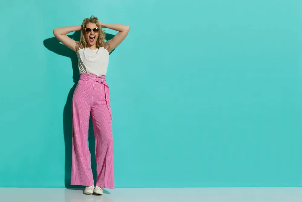 Young,Woman,In,Red,Striped,Wide,Leg,Trousers,And,Sneakers