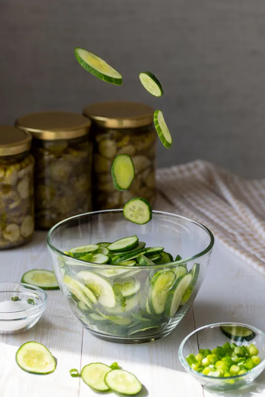 Cooking,Salad,With,Fresh,Cucumbers.,Flying,Slices,Of,Cucumbers,In