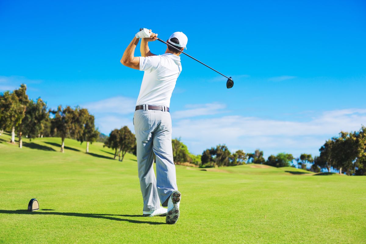 Golf,Player,Teeing,Off.,Man,Hitting,Golf,Ball,From,Tee