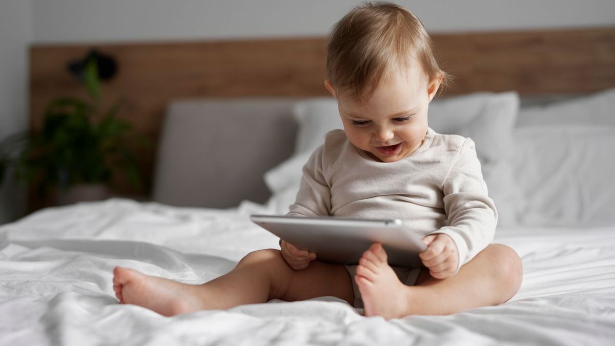 Caucasian little girl using digital tablet at home 