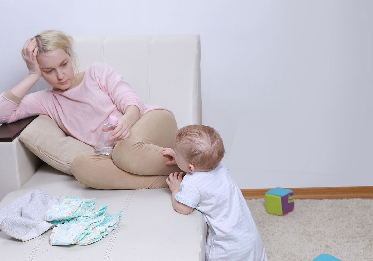 Woman,Sits,With,Her,Child,,Postpartum,Depression