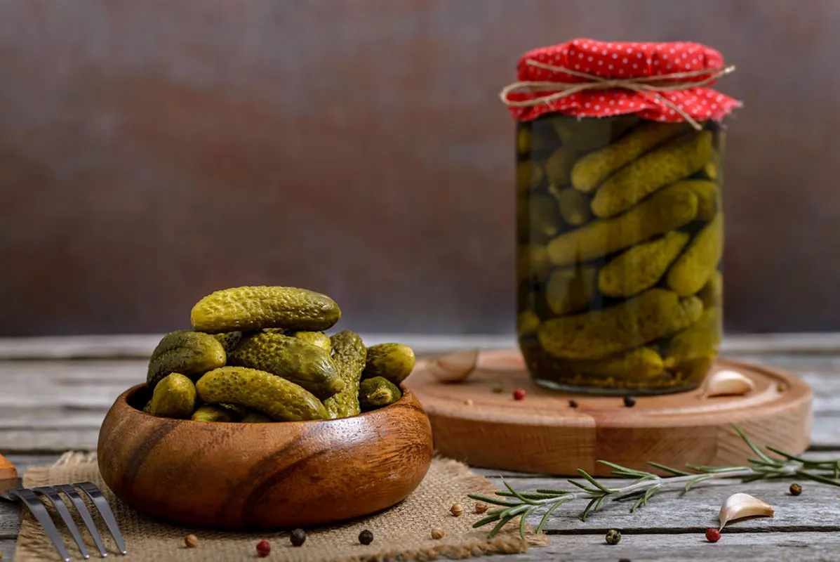 Bowl,And,Glass,Jar,Of,Pickled,Gherkins,With,Spices,On