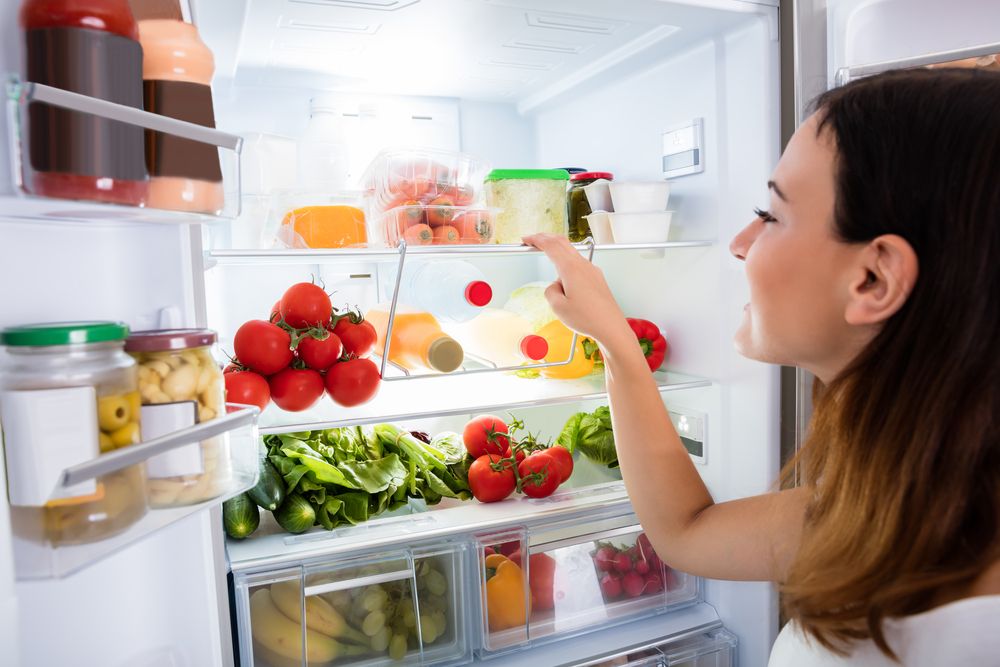 Close-up,Of,Young,Woman,Searching,For,Food,In,The,Fridge
