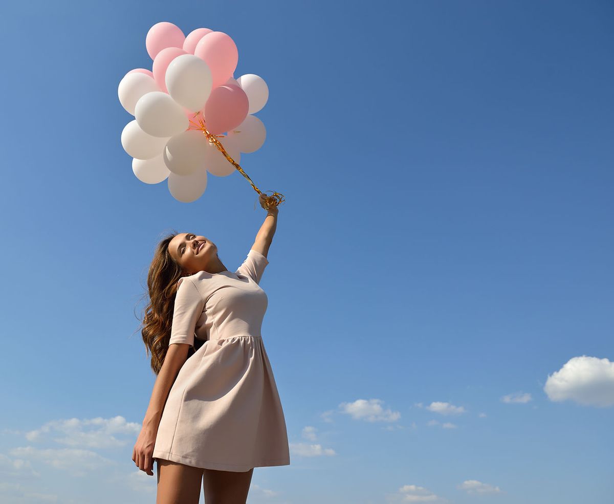 Fashion,Girl,With,Air,Balloons,Over,Blue,Sky