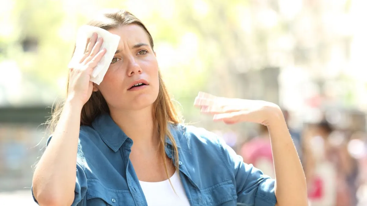 Unhappy,Woman,Sweating,Suffering,A,Heat,Stroke,And,Fanning,With