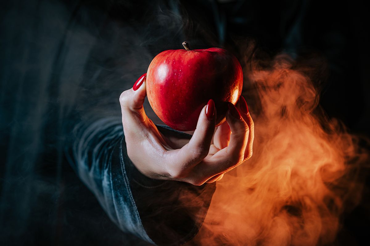 Woman,As,Witch,In,Black,Offers,Red,Apple,As,Symbol