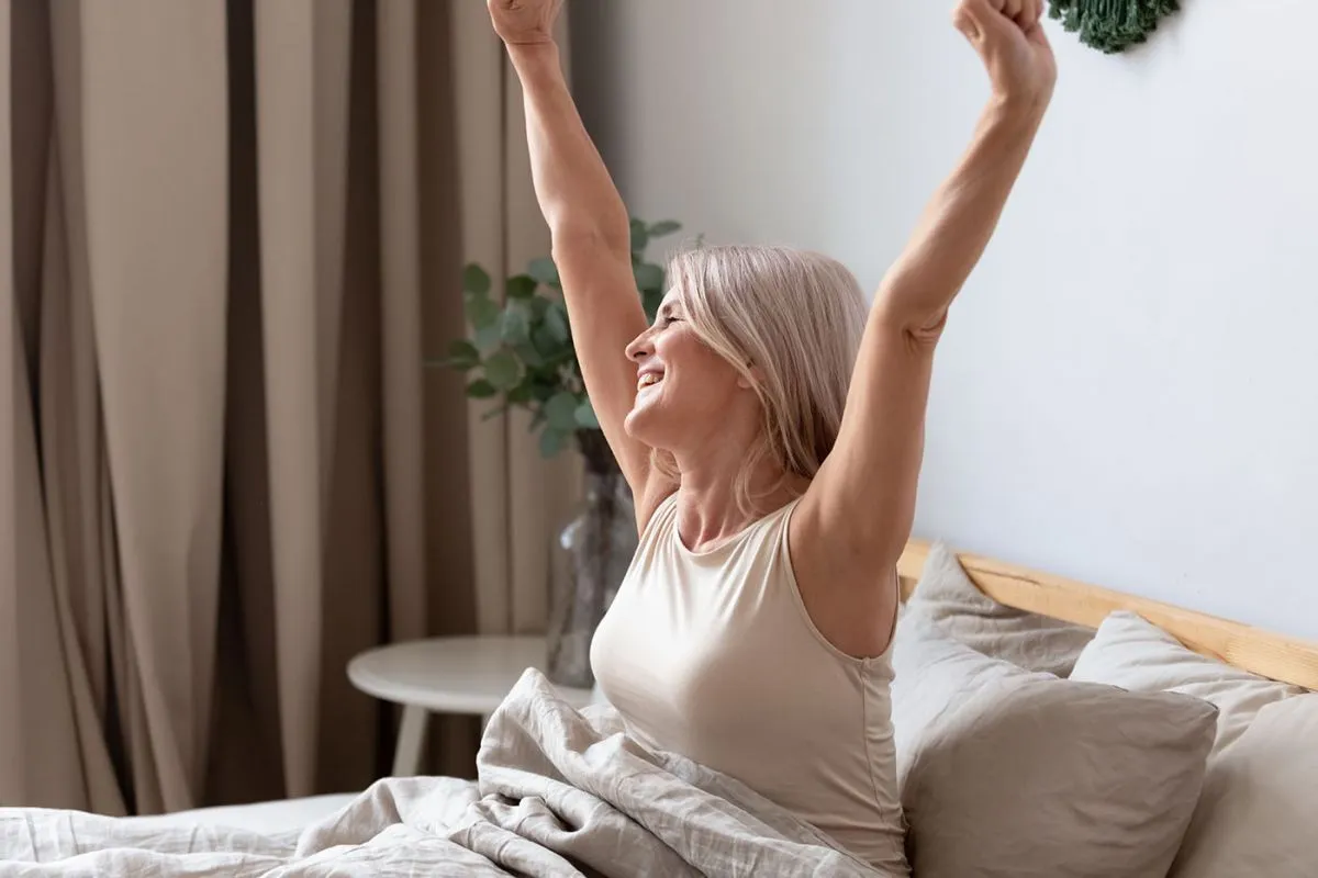Happy,Rested,Awakened,Woman,Stretching,Raised,Her,Hands,After,Waking