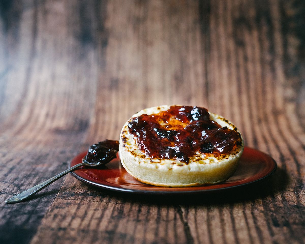 Fresh,Toasted,Crumpets,With,Jam,On,Red,Shiny,Plate
